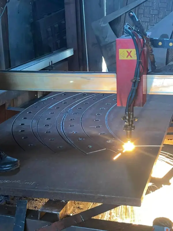 CNC plasma cutter profiling components from steel plate