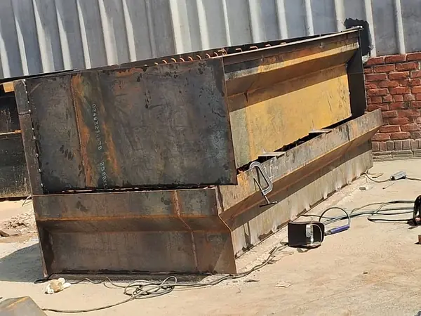 Heavy fabricated steel trough chute in the workshop yard