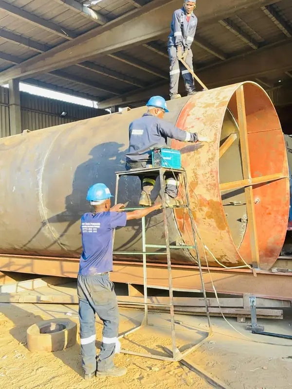 Noktech fabrication team working on a large steel tank shell