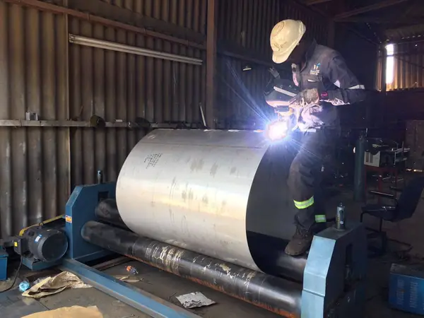 Rolling and welding a stainless steel cylinder