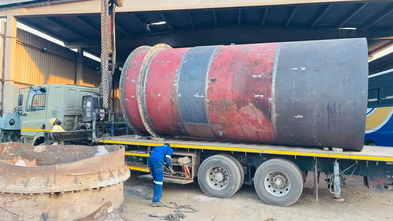 Large fabricated steel tank shell loaded onto a truck for delivery